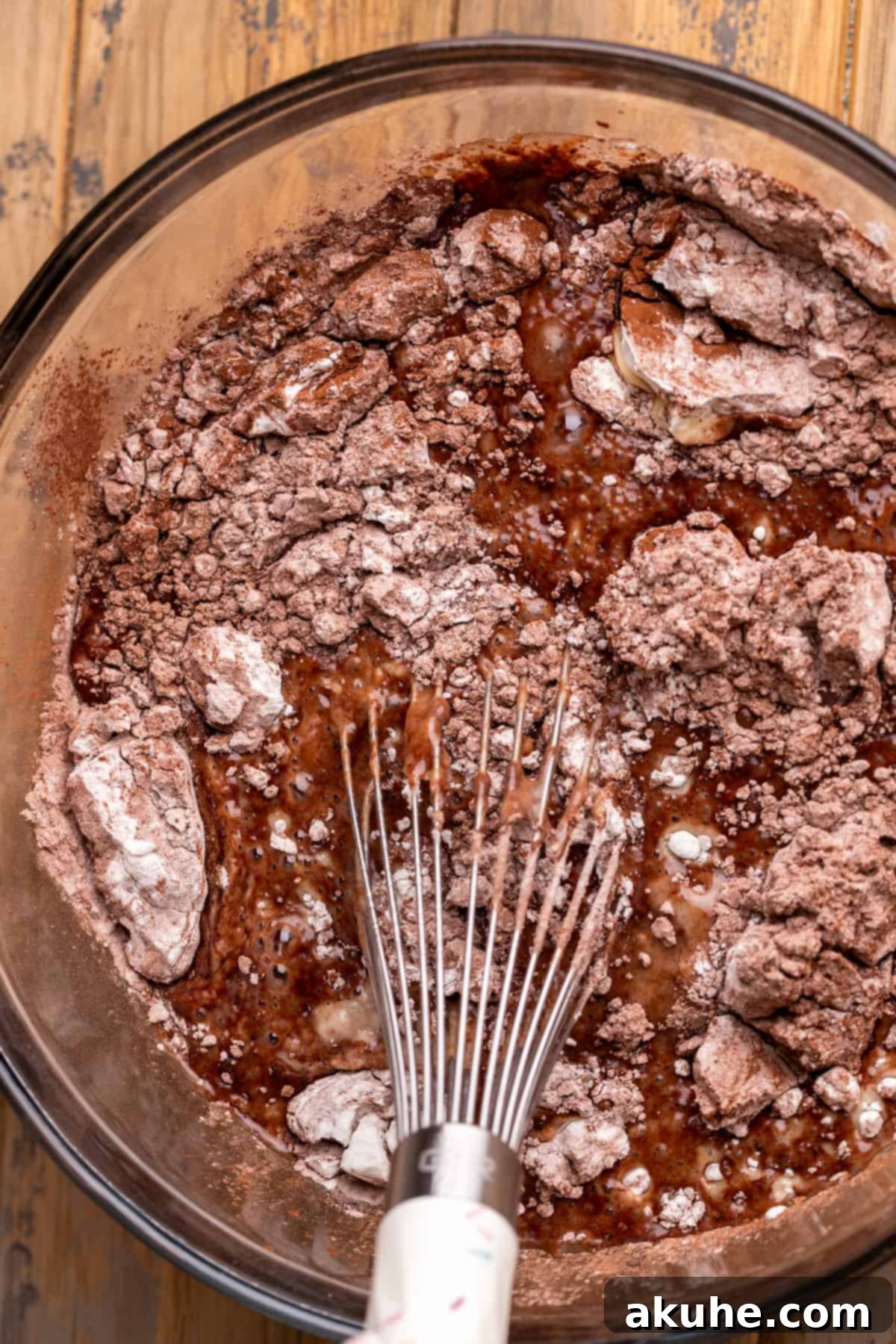 Wet ingredients freshly mixed in a bowl, ready to be combined with dry ingredients for the chocolate cake.