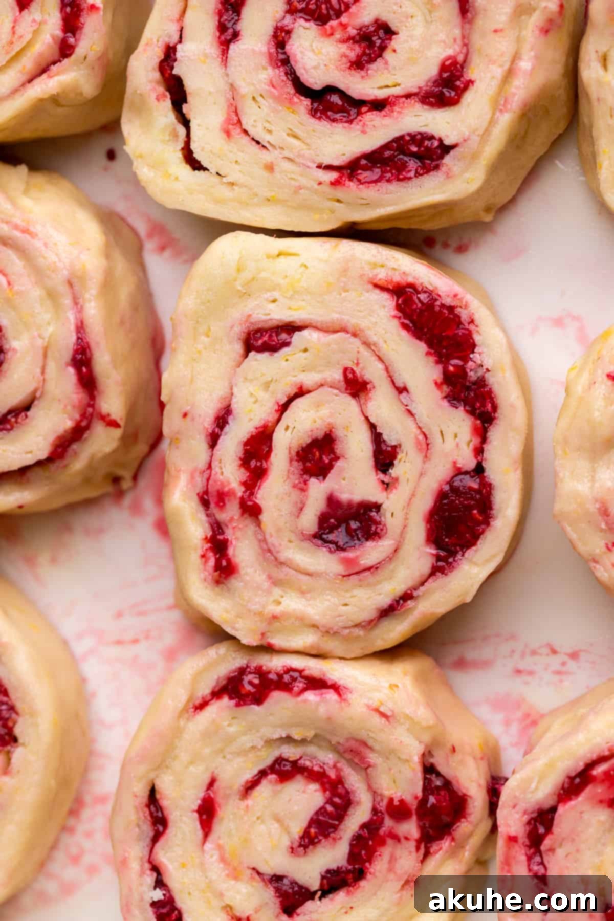 Tangy Lemon Raspberry Buns 5 Unbaked lemon raspberry rolls arranged in a baking pan, ready for their second rise.