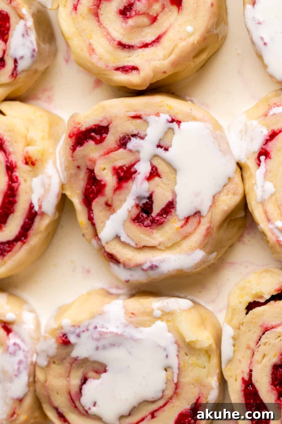 Tangy Lemon Raspberry Buns 6 Heavy cream being poured over unbaked lemon raspberry rolls in a baking pan, prior to baking.