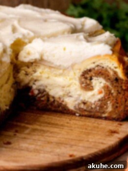Carrot Cake Swirl Cheesecake 14 A slice of carrot cake cheesecake, showing the beautiful layers, on a platter.