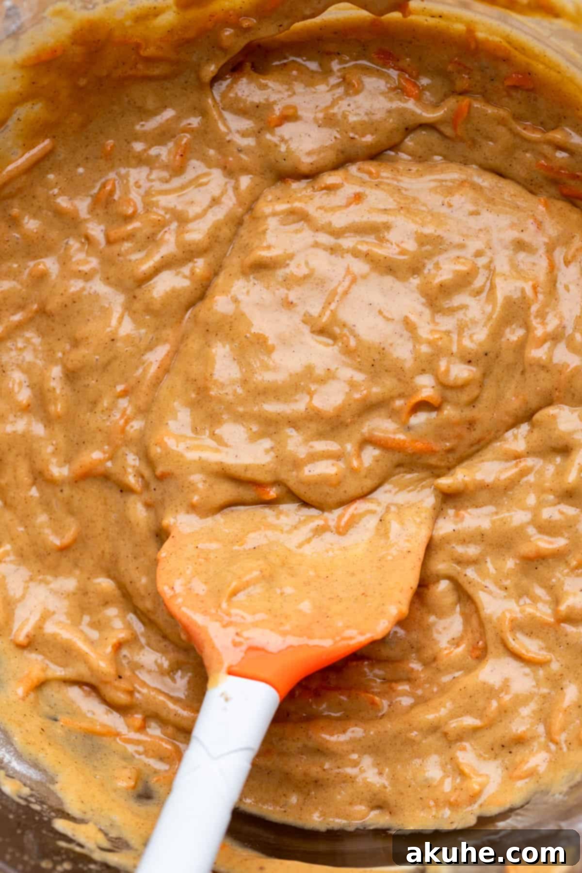 Carrot Cake Swirl Cheesecake 6 A glass bowl filled with the completed carrot cake batter, ready for layering.