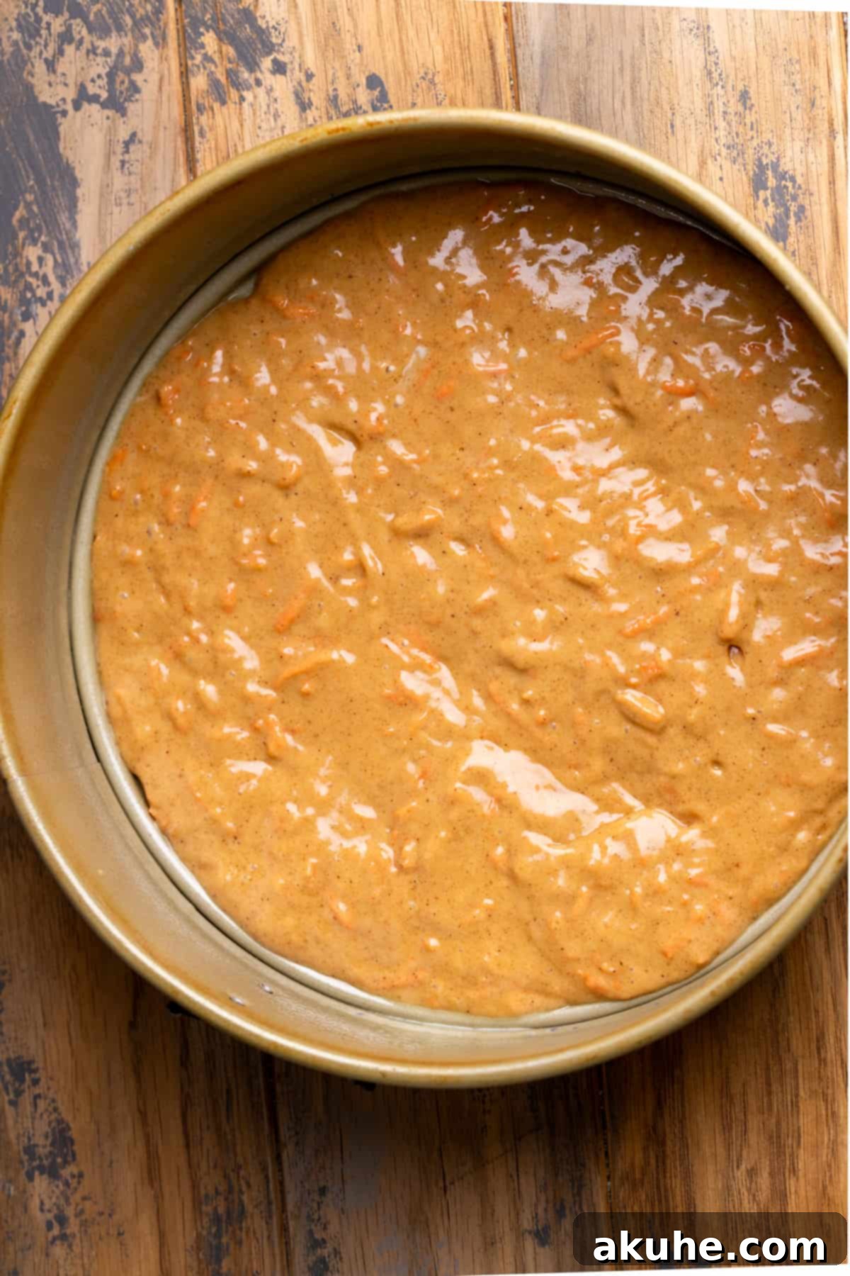 Carrot Cake Swirl Cheesecake 7 The first layer of carrot cake batter evenly spread in a springform pan.