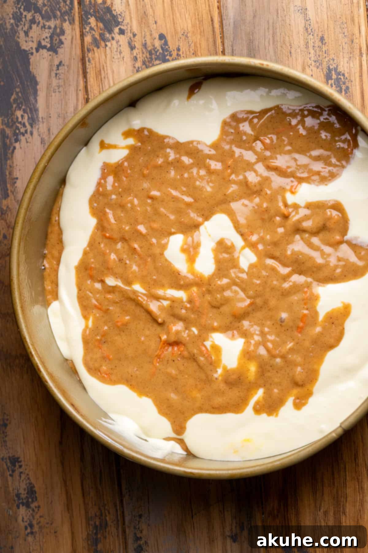 Carrot Cake Swirl Cheesecake 8 Partially layered cheesecake and carrot cake batter, showing the beginning of the marbling effect.