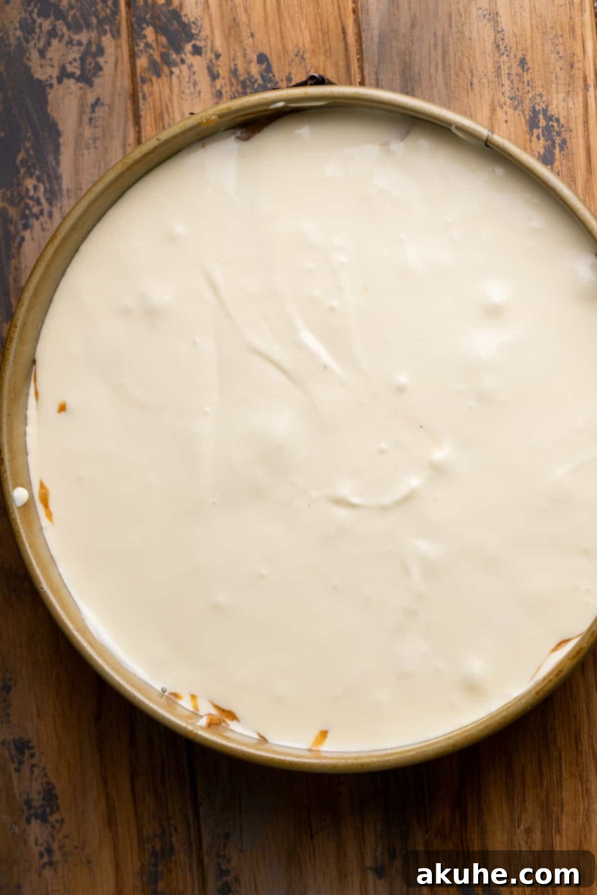 Carrot Cake Swirl Cheesecake 9 The final layers of cheesecake and carrot cake batter in the springform pan, ready for baking.