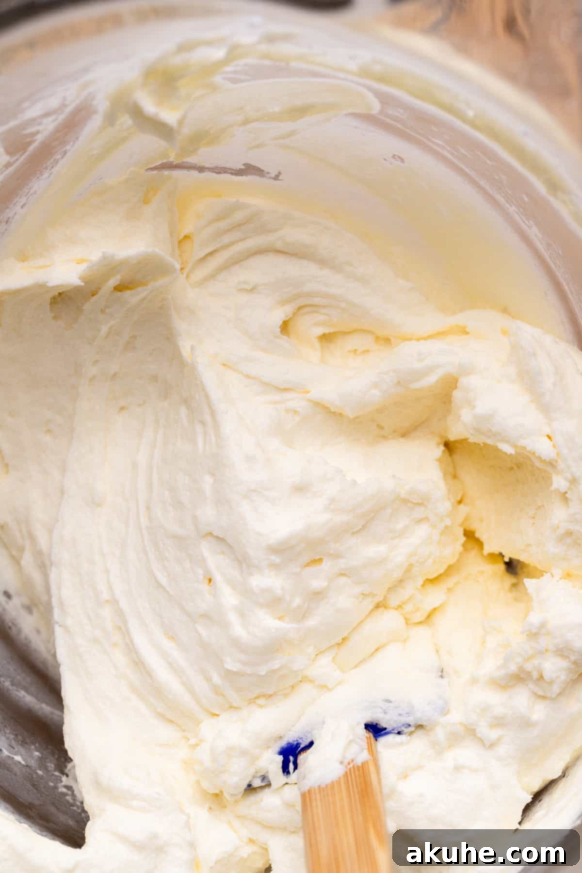 Carrot Cake Swirl Cheesecake 10 A glass bowl filled with fluffy, ready-to-spread cream cheese frosting.