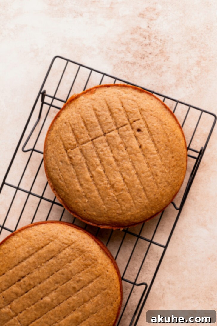 Decadent Caramel Apple Delight 6 Baked cake layers cooling on a wire rack, with one layer having its dome cut off.