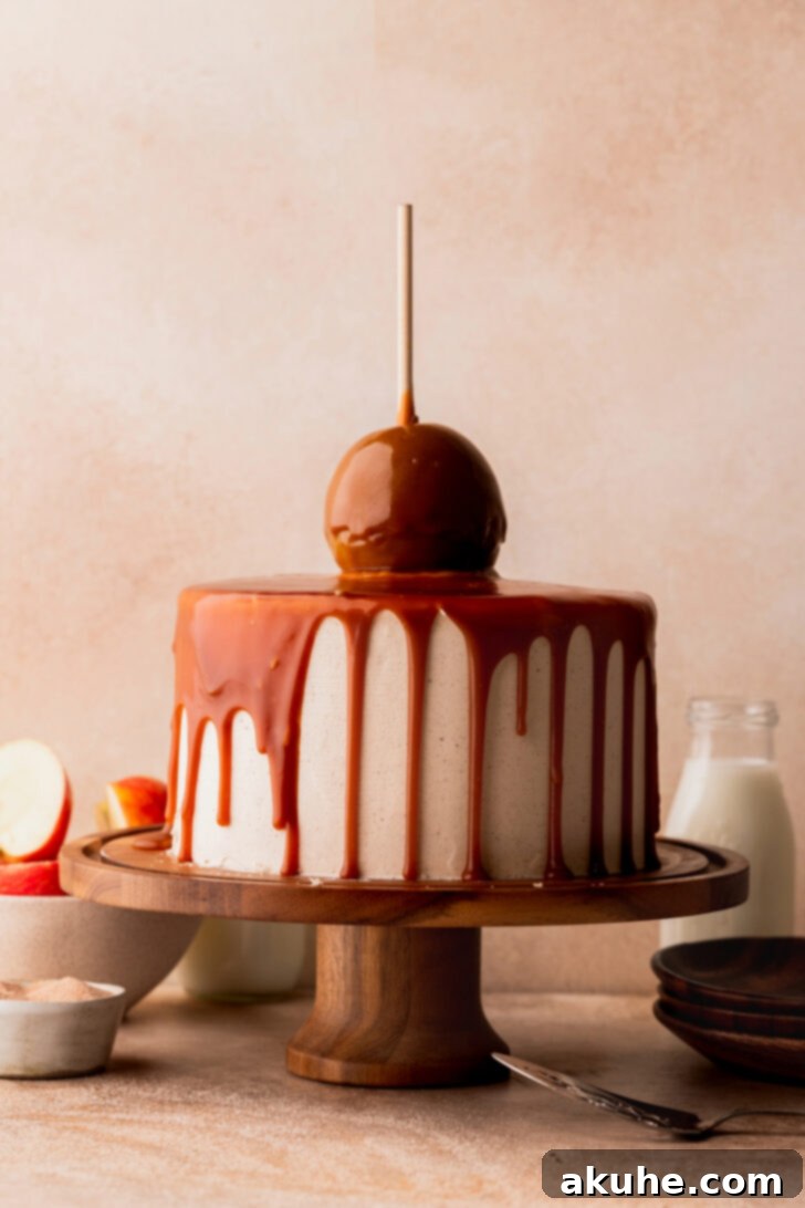 Decadent Caramel Apple Delight 10 Beautifully decorated caramel apple cake with a caramel drip on a cake stand.