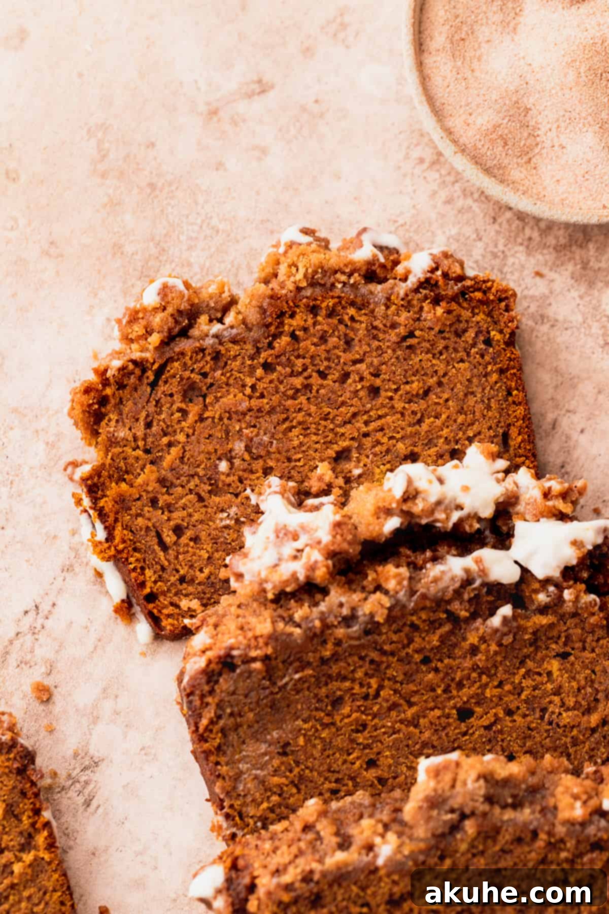 Spiced Pumpkin Loaf with Cream Cheese Frosting 11 Stacks of pumpkin bread slices with cream cheese frosting, creating an inviting display.