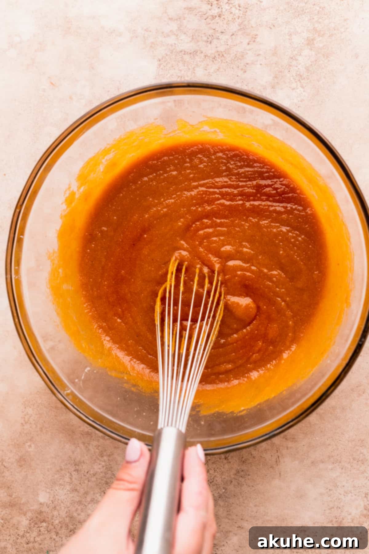 Spiced Pumpkin Loaf with Cream Cheese Frosting 5 Wet ingredients for pumpkin bread mixed in a bowl.