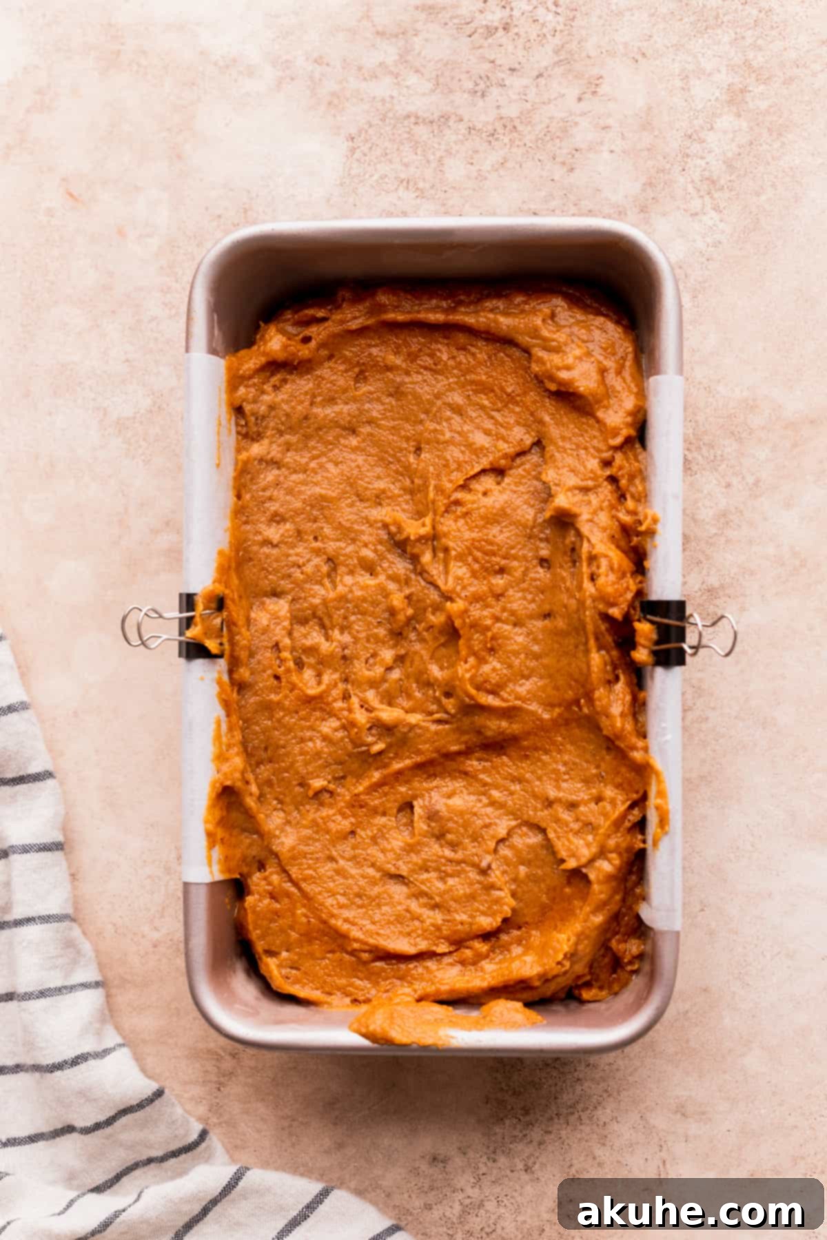 Spiced Pumpkin Loaf with Cream Cheese Frosting 7 Pumpkin bread batter poured into a loaf pan, ready for topping.