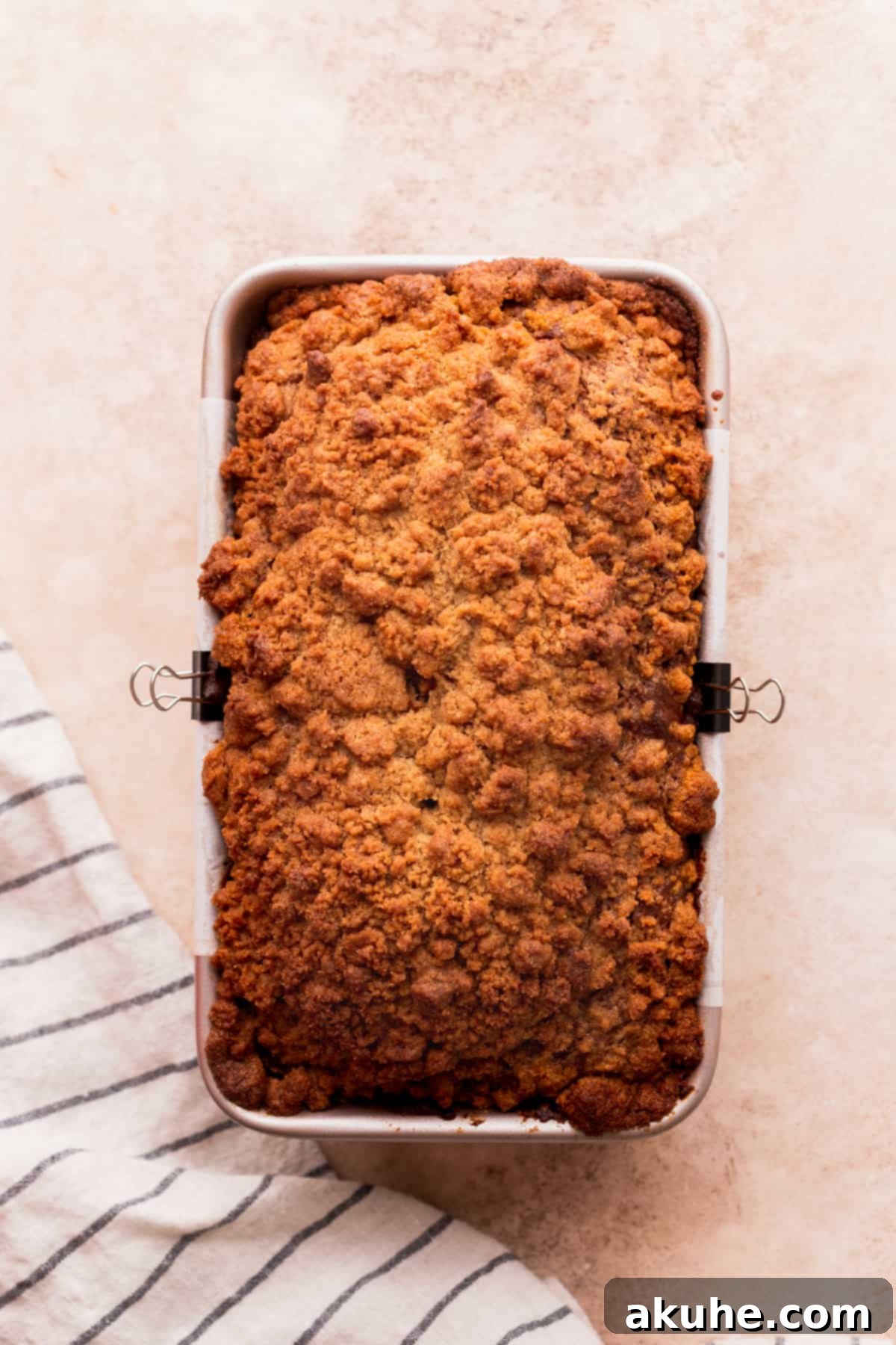 Spiced Pumpkin Loaf with Cream Cheese Frosting 9 Freshly baked pumpkin bread in the loaf pan, cooling slightly.