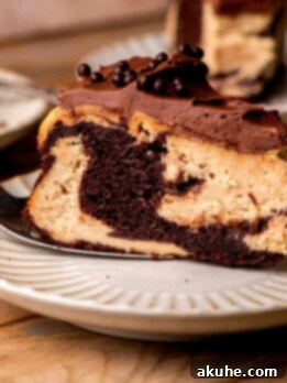 Ultimate Peanut Butter Chocolate Cheesecake 13 Piece of chocolate peanut butter cheesecake on a plate.