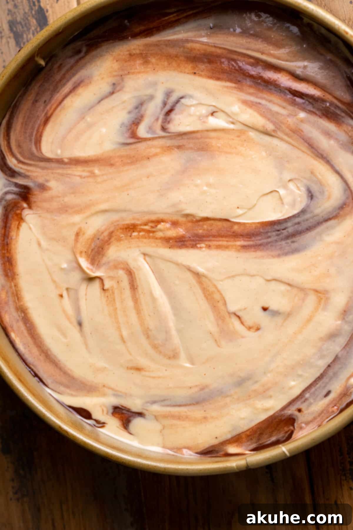 Ultimate Peanut Butter Chocolate Cheesecake 7 A close-up view of the cheesecake batter nestled in the springform pan, revealing its creamy texture before baking.
