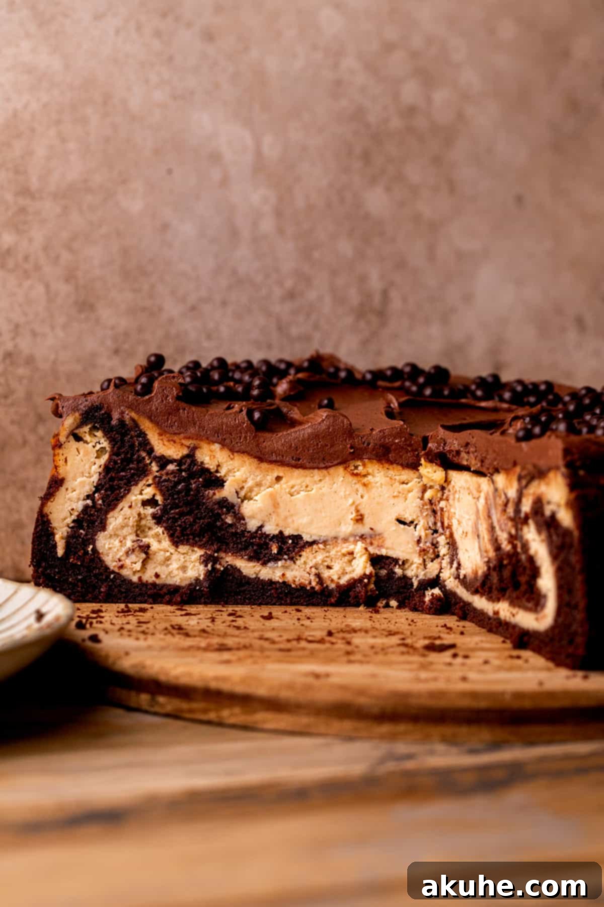Ultimate Peanut Butter Chocolate Cheesecake 10 A stunning side profile of the chocolate peanut butter cheesecake, highlighting its distinct, marbled layers of cake and cheesecake.