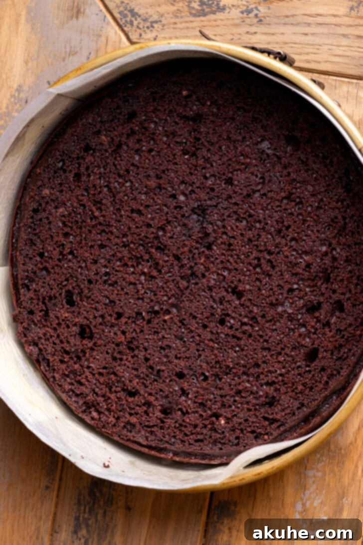 Decadent Chocolate Mousse Dream 8 Cake in a springform pan with parchment paper lining the sides.