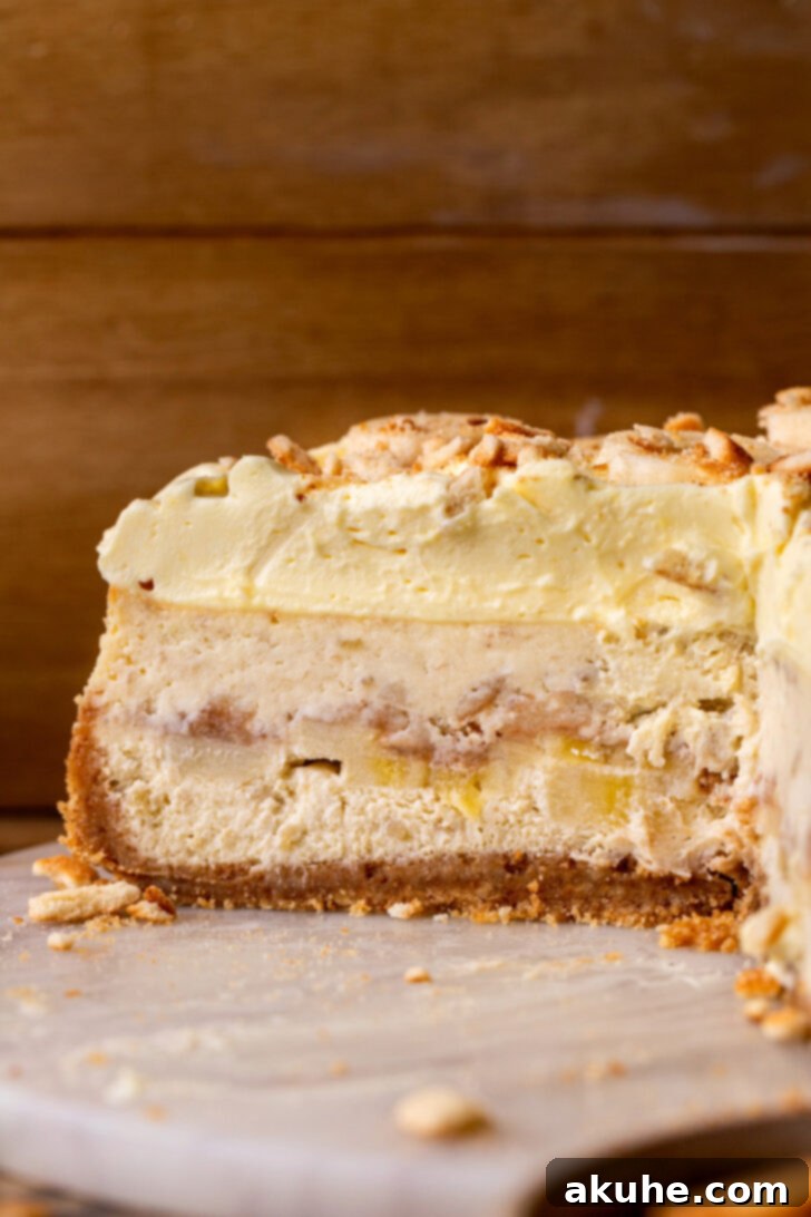 Southern Banana Pudding Cheesecake 11 Side view of a whole banana pudding cheesecake, highlighting the height and layers.