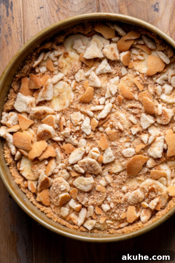 Southern Banana Pudding Cheesecake 6 A layer of sliced bananas and crushed Nilla Wafers placed on top of half the cheesecake batter in the pan.