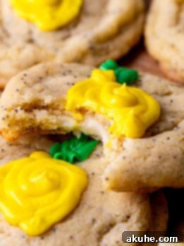 Zesty Lemon Poppy Seed Cookies 11 A bite missing from a lemon poppy seed cookie.