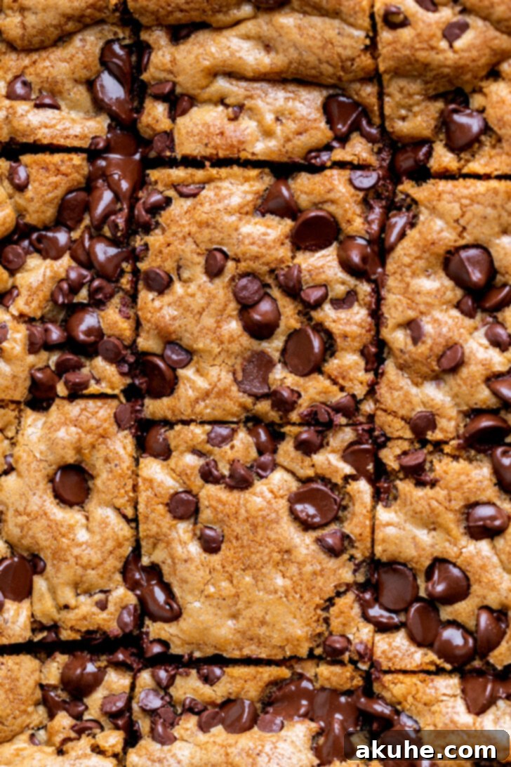 Nutty Brown Butter Chocolate Chip Cookie Slices 2 Golden brown top of freshly baked brown butter chocolate chip cookie bars, showcasing a perfectly crispy yet soft appearance.