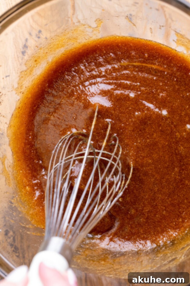 Nutty Brown Butter Chocolate Chip Cookie Slices 5 A glass bowl filled with the smoothly whisked wet ingredients, ready for the dry components.