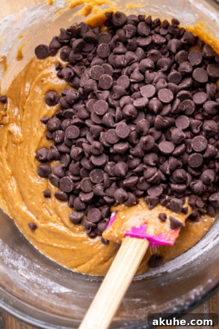 Nutty Brown Butter Chocolate Chip Cookie Slices 6 An inviting close-up of a generous mix of chocolate chips resting atop the prepared cookie dough in a bowl.