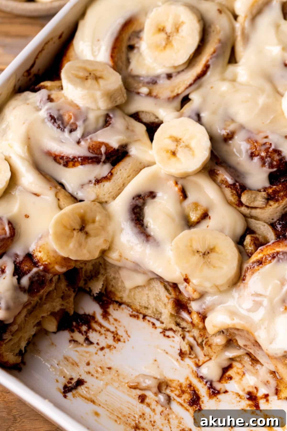 Banana Swirl Buns 8 Side view of freshly baked Banana Cinnamon Rolls in a pan, showcasing their fluffy texture and golden tops.