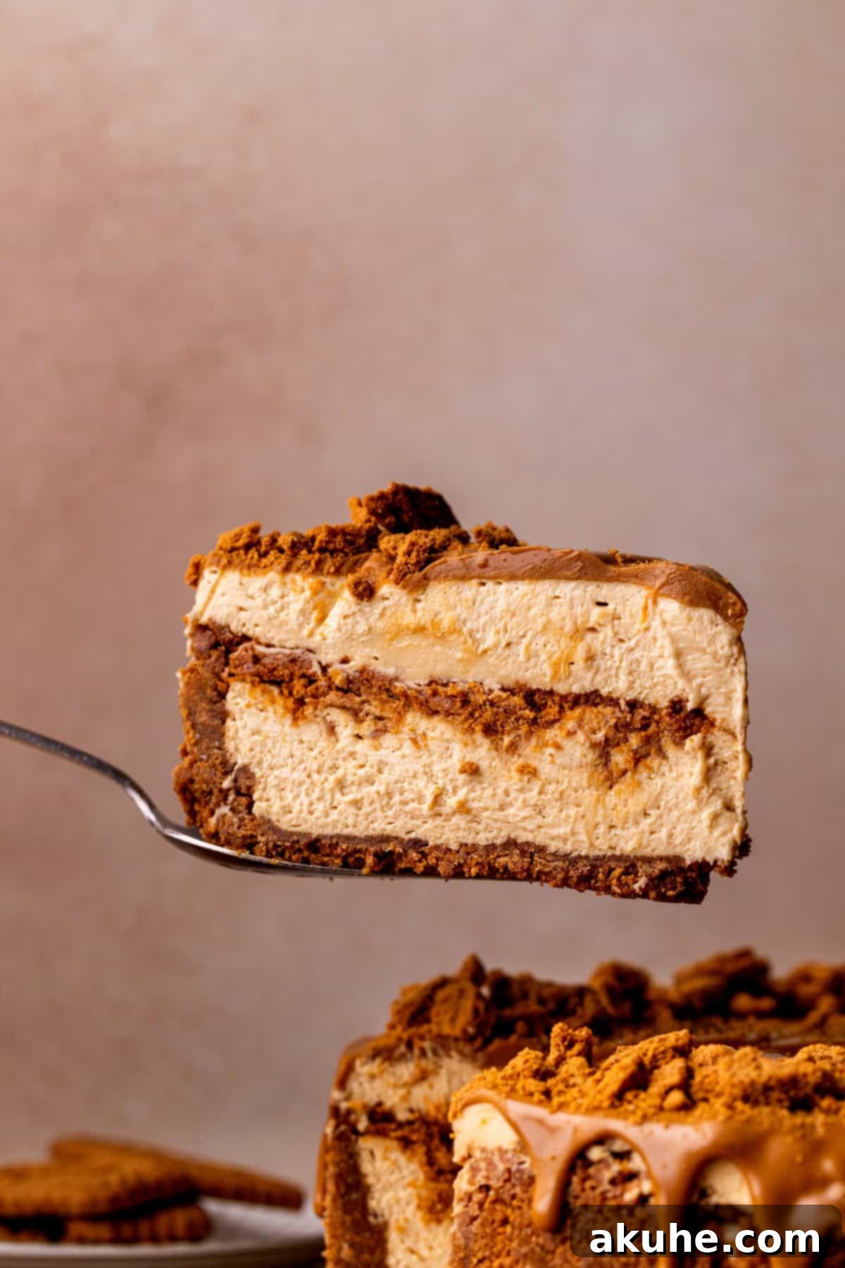 Decadent No-Bake Biscoff Cheesecake 3 Slice in the air.