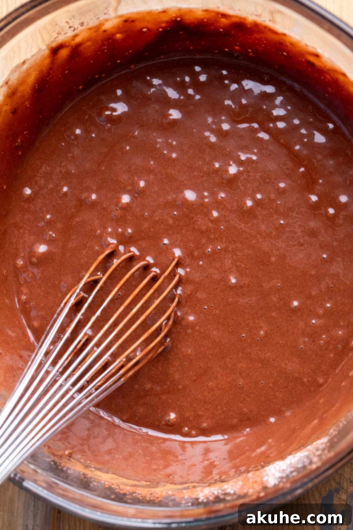 Decadent Chocolate Delights 5 Smooth chocolate cupcake batter in a glass mixing bowl.