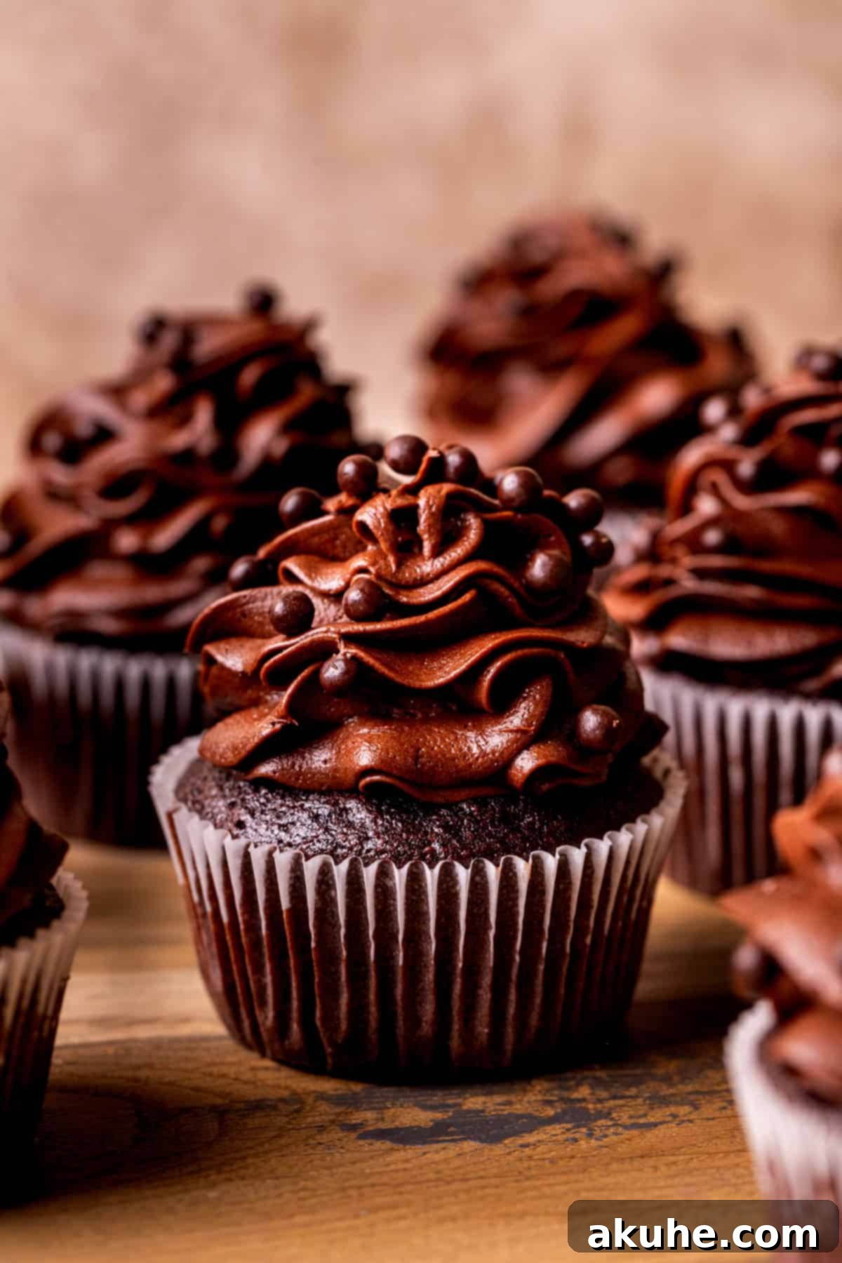 Decadent Chocolate Delights 9 A single perfectly decorated chocolate cupcake, ready to be eaten.