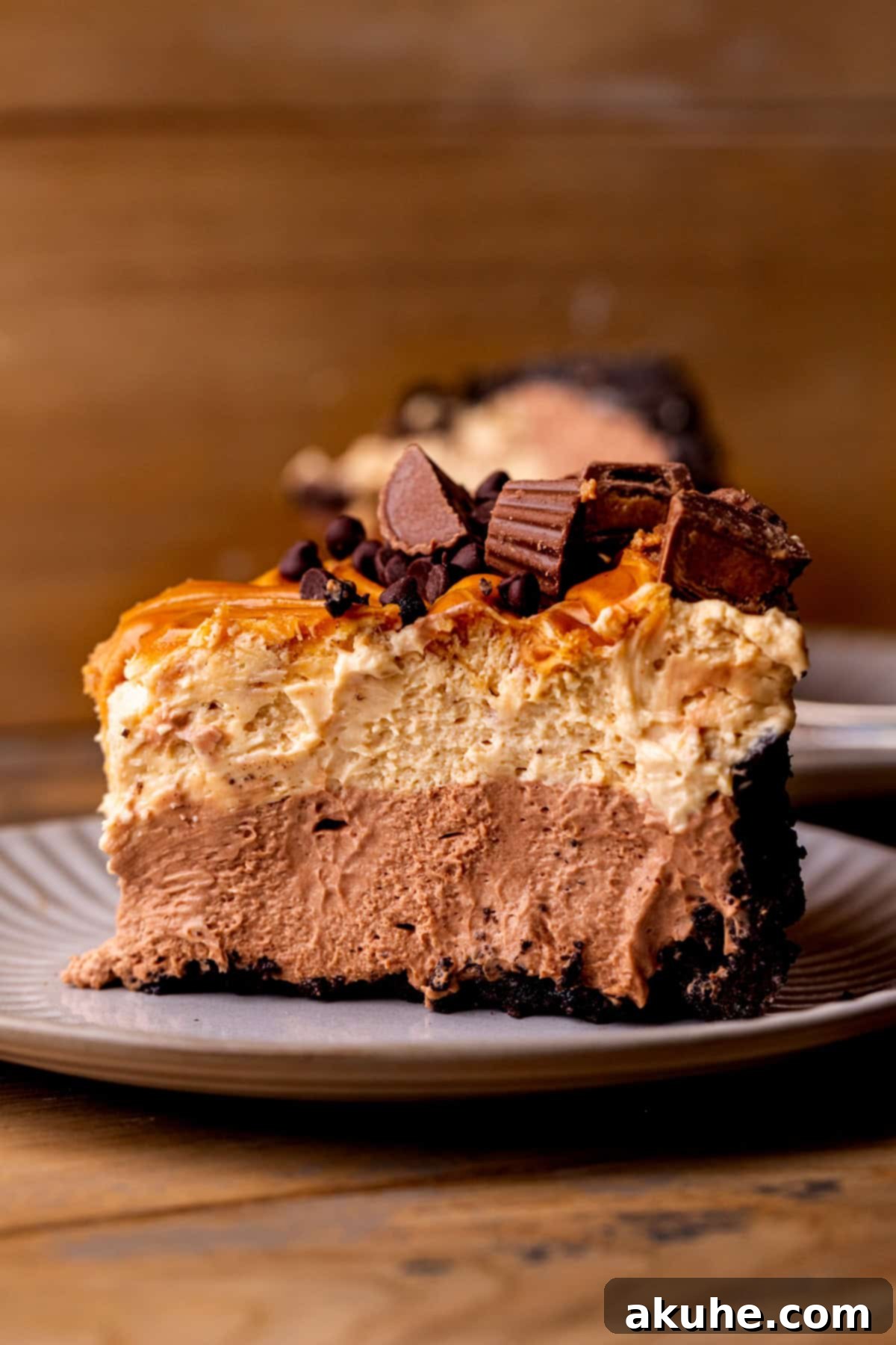Side view of chocolate peanut butter pie on a plate, highlighting its distinct layers.