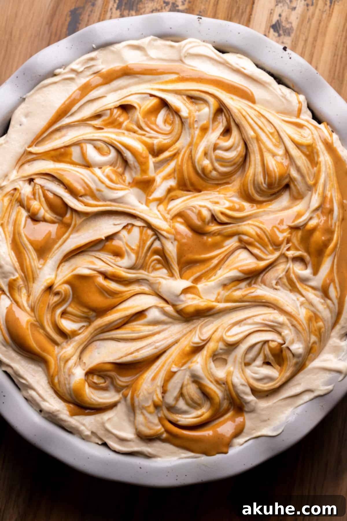 Close-up of a no-bake chocolate peanut butter pie with an artistic swirl of melted peanut butter on top.