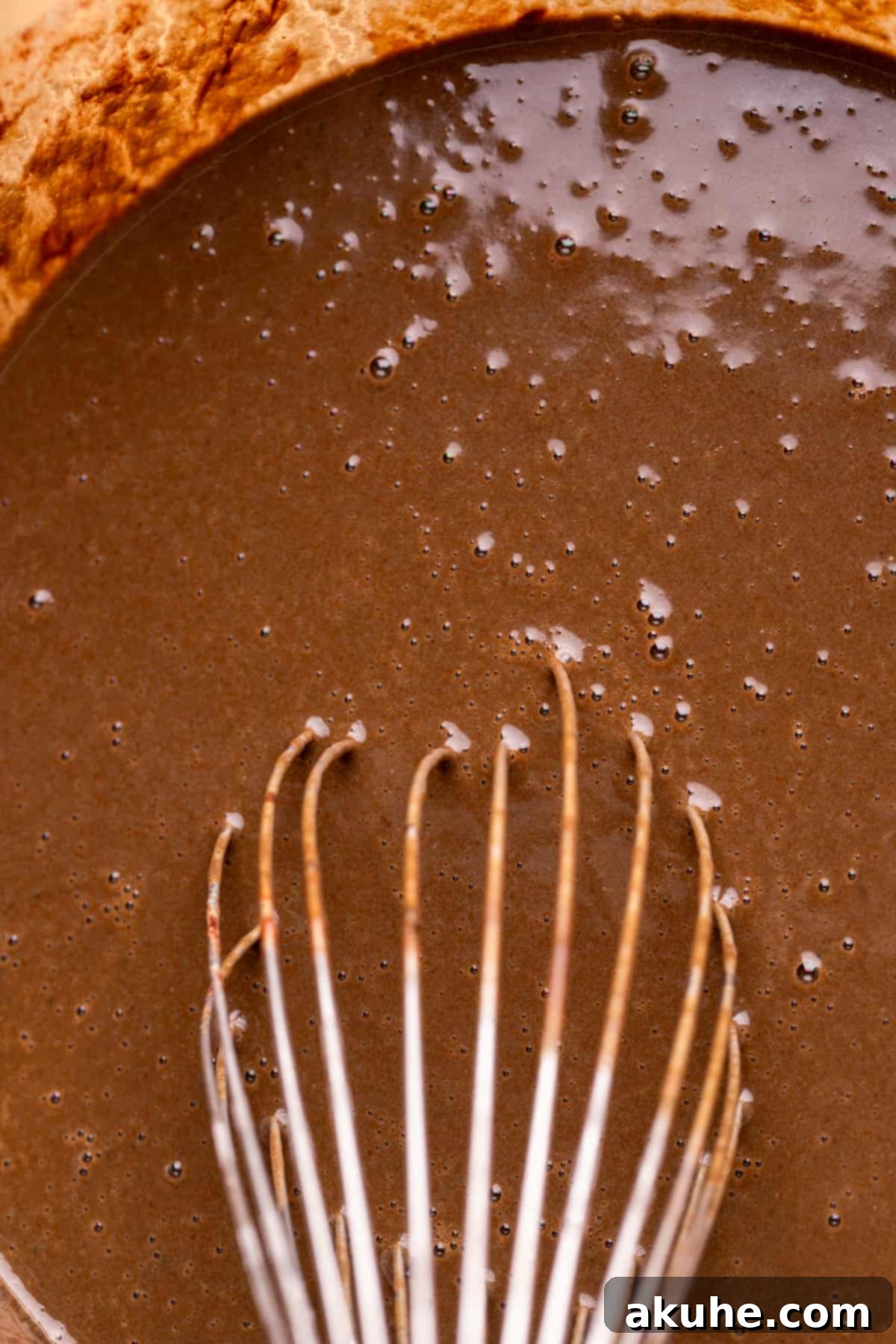 Bewitching Halloween Chocolate Cake 4 A glass bowl filled with the wet ingredients for the black velvet cake, including oil, vanilla, eggs, melted chocolate, and buttermilk.