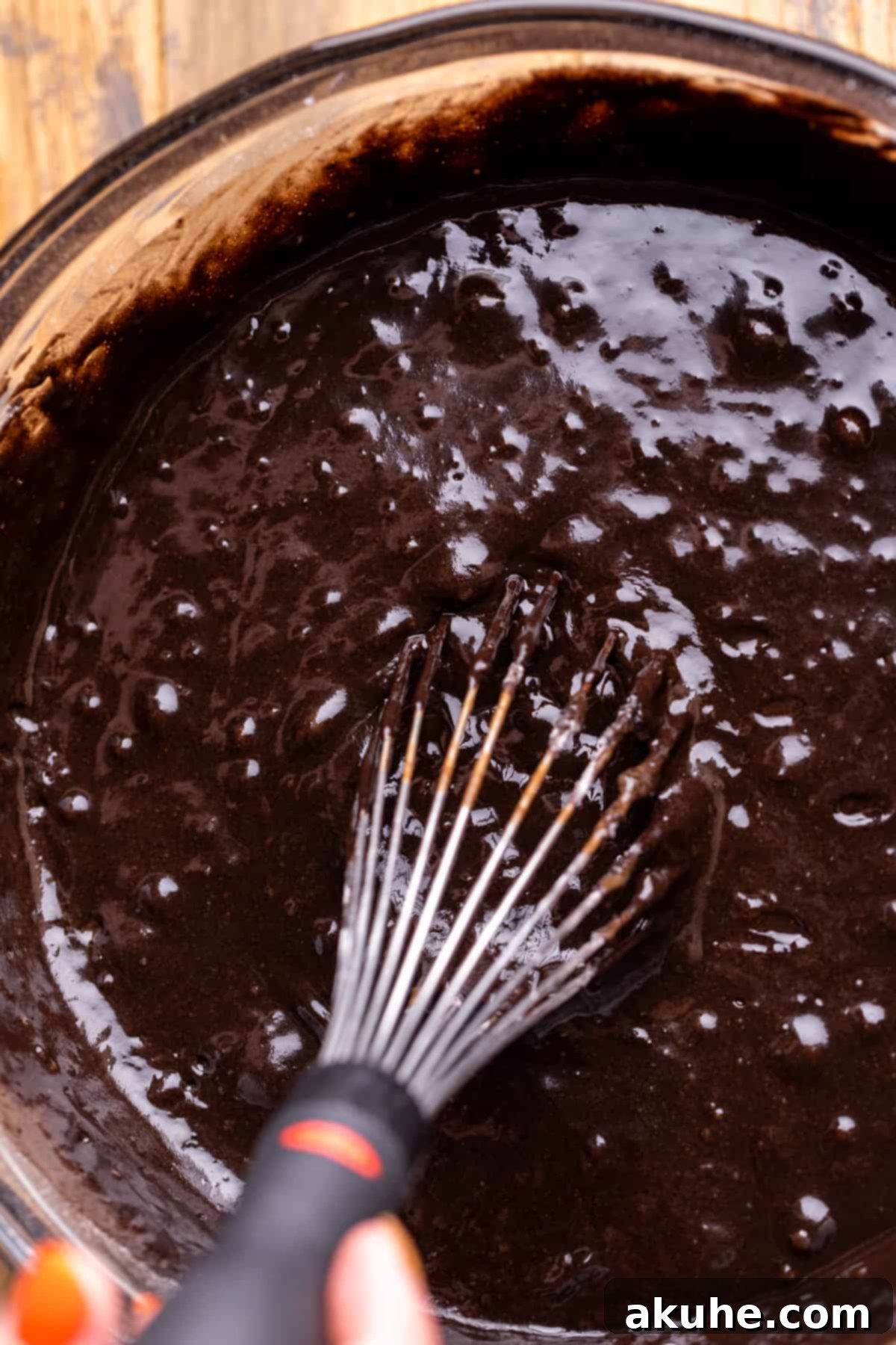 Bewitching Halloween Chocolate Cake 5 The dark, rich black cake batter in a clear glass bowl, showcasing its deep color before baking.