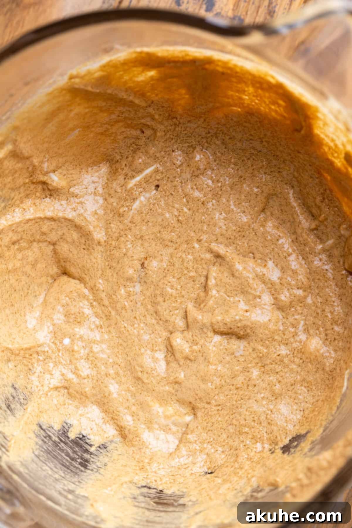 Wet ingredients for cupcakes in a glass bowl after mixing.