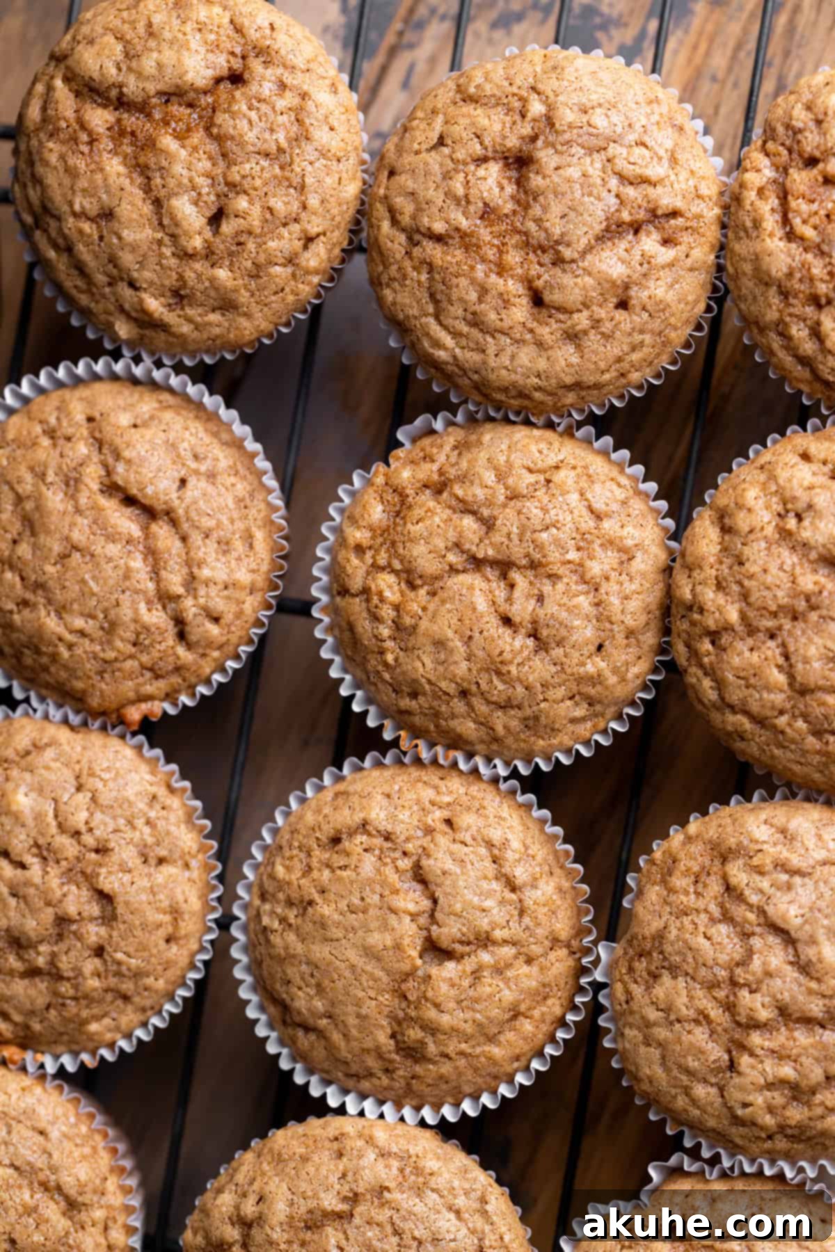 Freshly baked cinnamon cupcakes cooling on a wire rack.