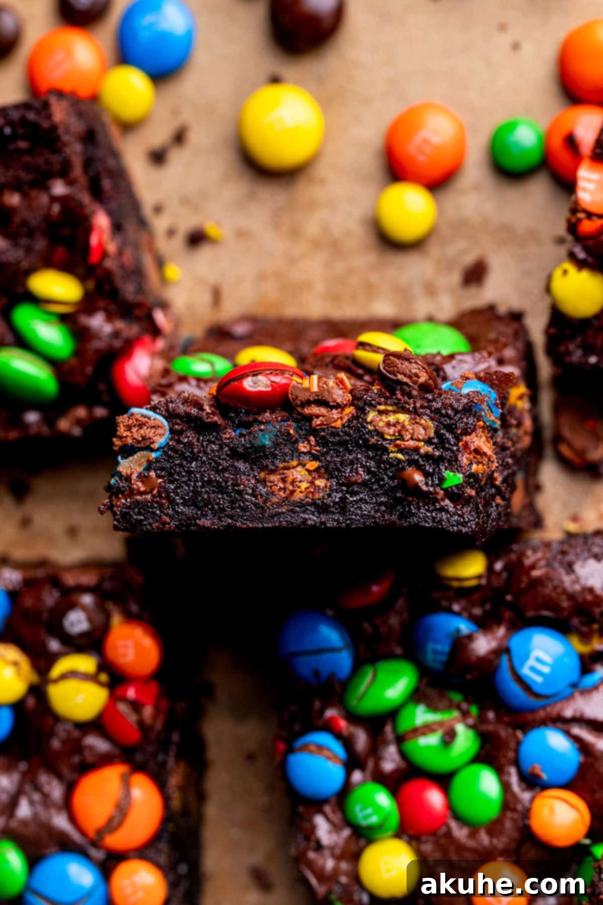 Decadent Fudgy M and M Brownies 3 A single fudgy M&M brownie, showcasing its dense texture and colorful candy pieces.