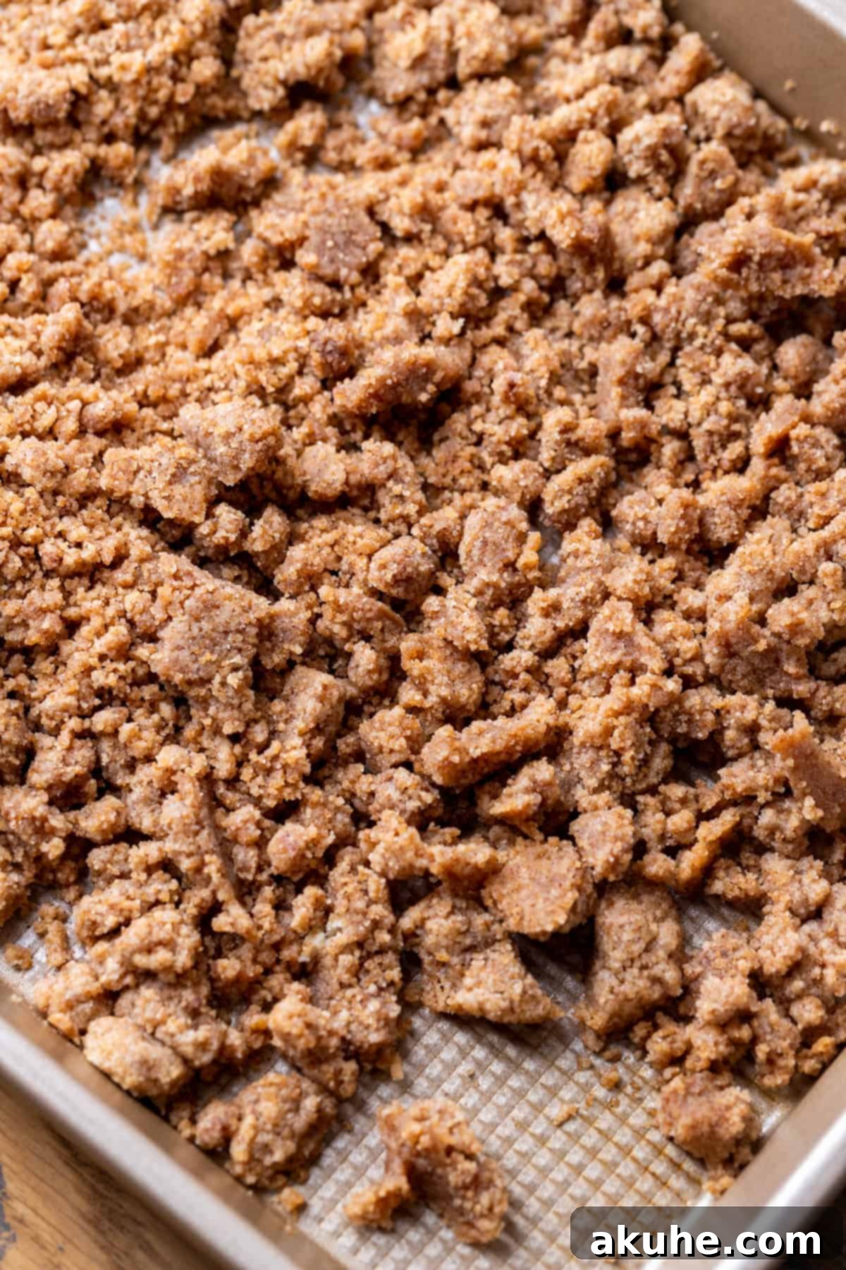 Baked cinnamon crumble cooling on a cookie sheet.