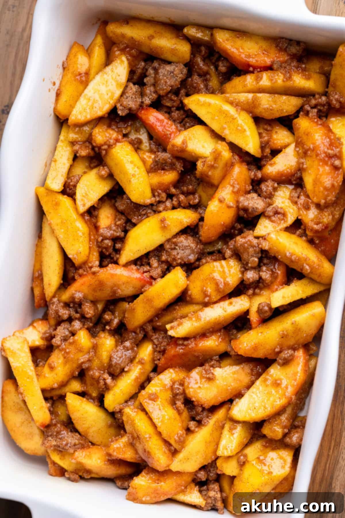 Peach filling with cinnamon crumble mixed in, spread in a casserole pan before baking.