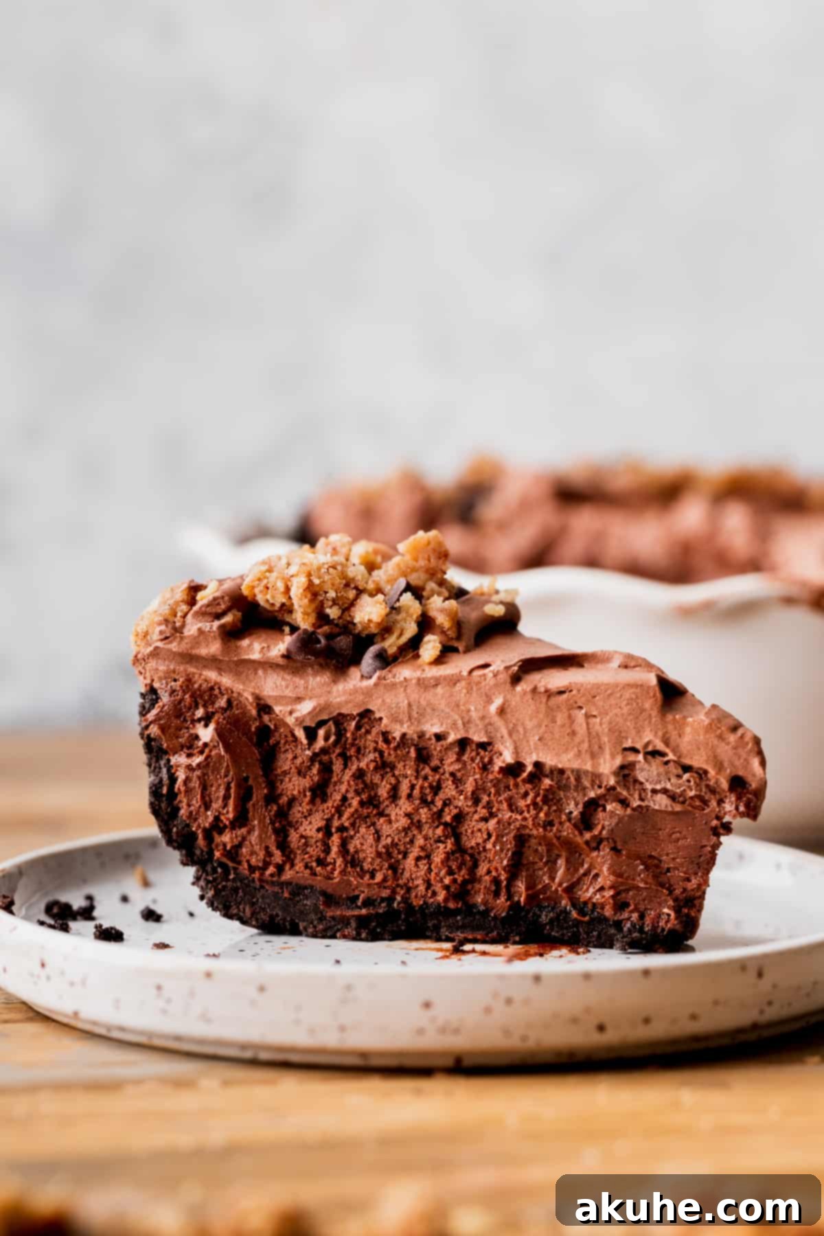 One slice of chocolate pie on a plate, showcasing its layers.