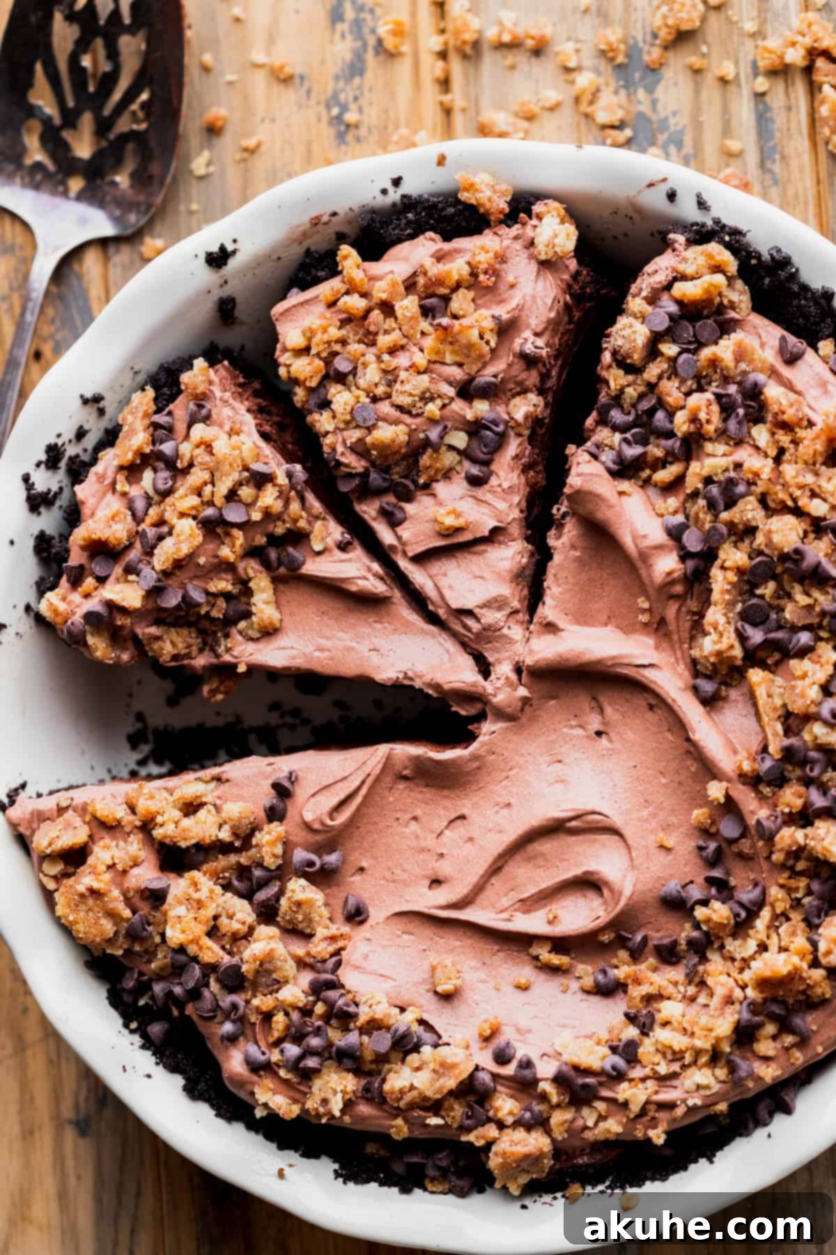 Top view of a chocolate pie with slices already taken out, showing the layers.