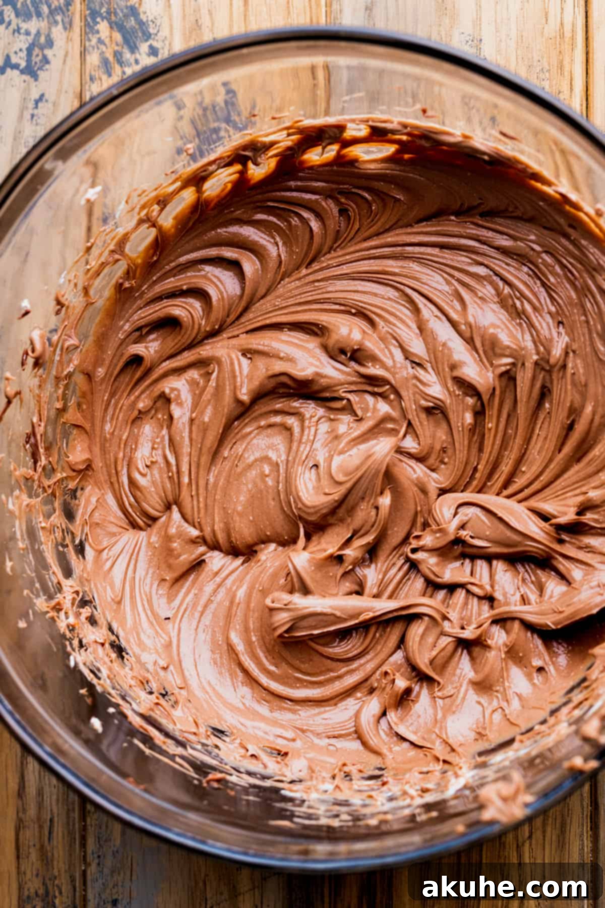 Whipped cream cheese and nutella in a glass bowl, showcasing its smooth texture.