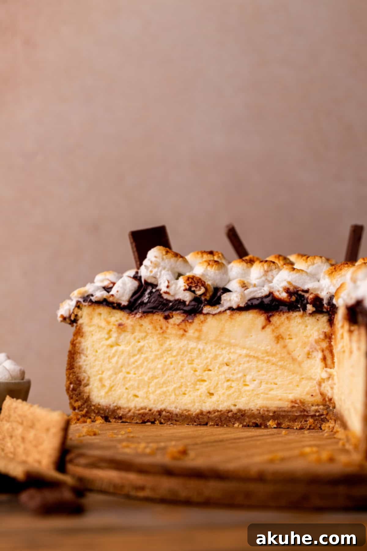 S'mores cheesecake open on a platter, showcasing its distinct layers.