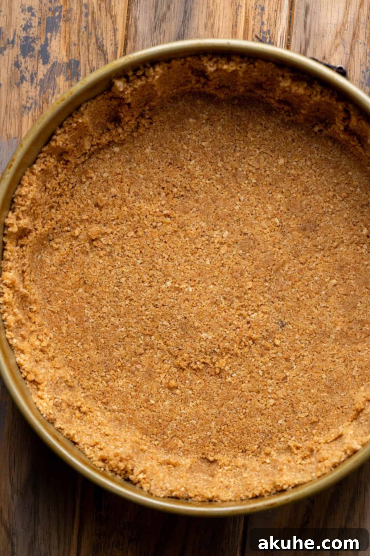 A perfectly prepared graham cracker crust in a springform pan.