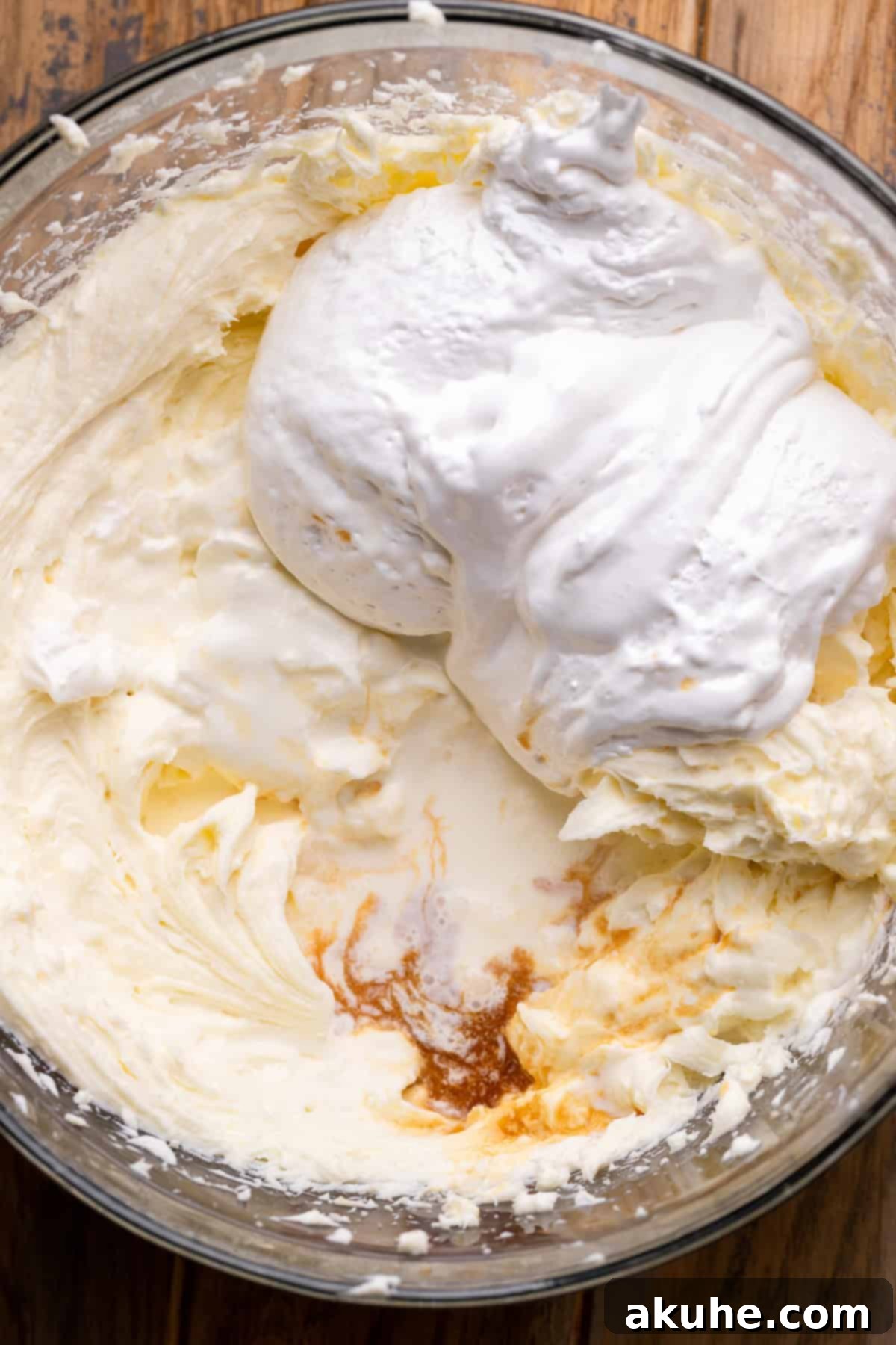 Marshmallow fluff being added to the cheesecake batter for the marshmallow creme cheesecake layer.