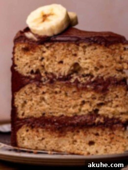 Decadent Banana Chocolate Dream Cake 12 One slice of banana cake with chocolate frosting on a plate.