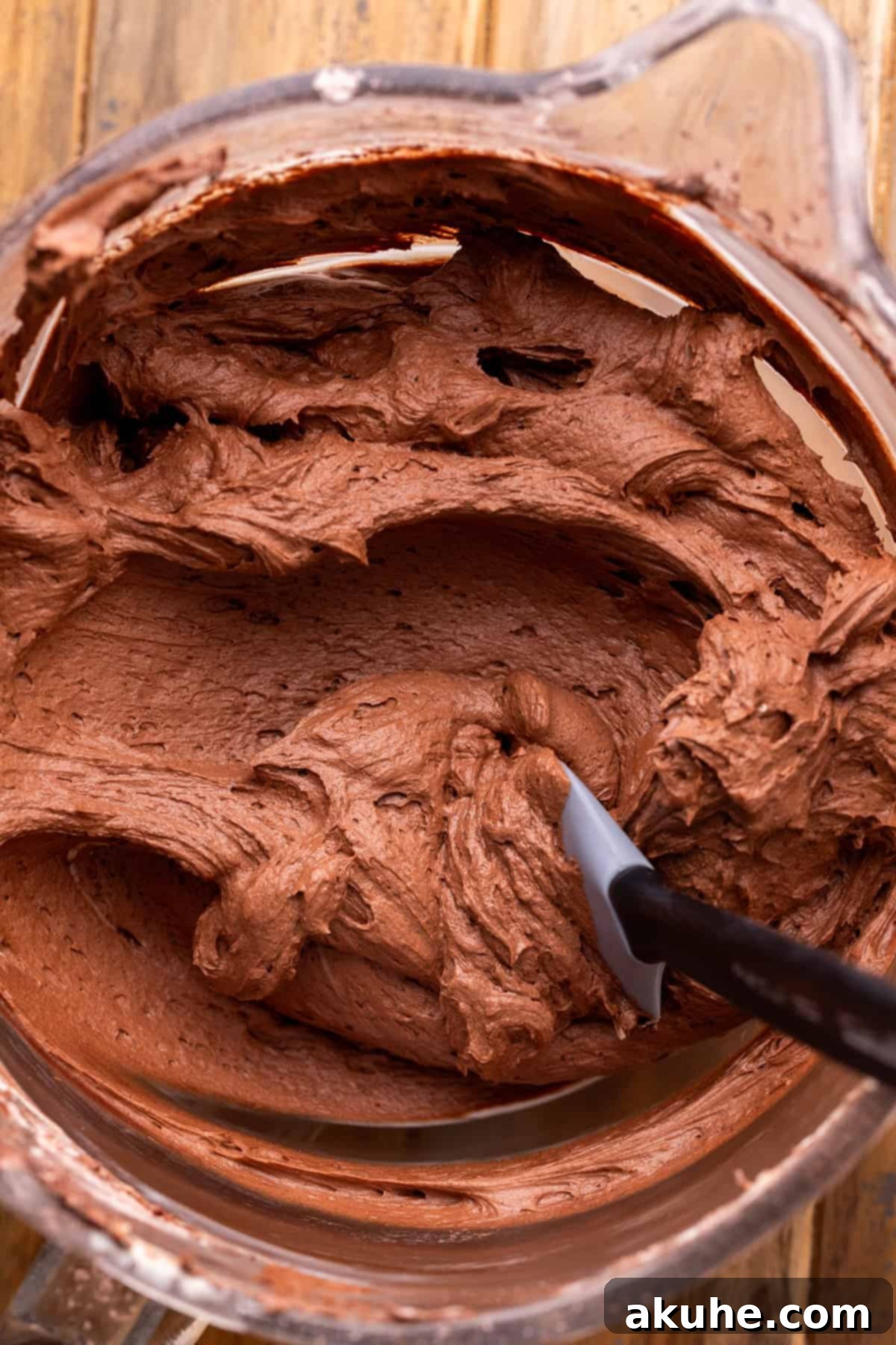 Decadent Banana Chocolate Dream Cake 7 Fluffy chocolate cream cheese frosting in a glass bowl, ready for cake assembly.