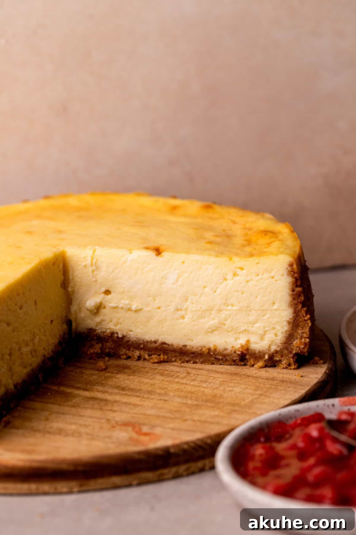 Side view of new york style cheesecake, showcasing its height and creamy texture.