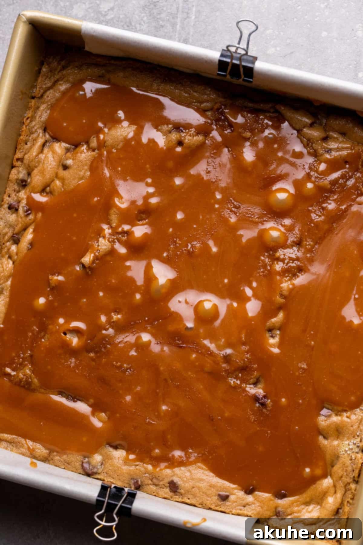 Decadent Caramel Cookie Bars 8 Gooey caramel expertly spread over the partially baked cookie dough in a pan.