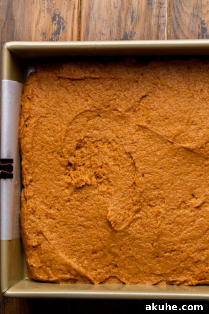 Autumn Pumpkin Streusel Cake 7 Pumpkin cake batter spread evenly in a baking pan.
