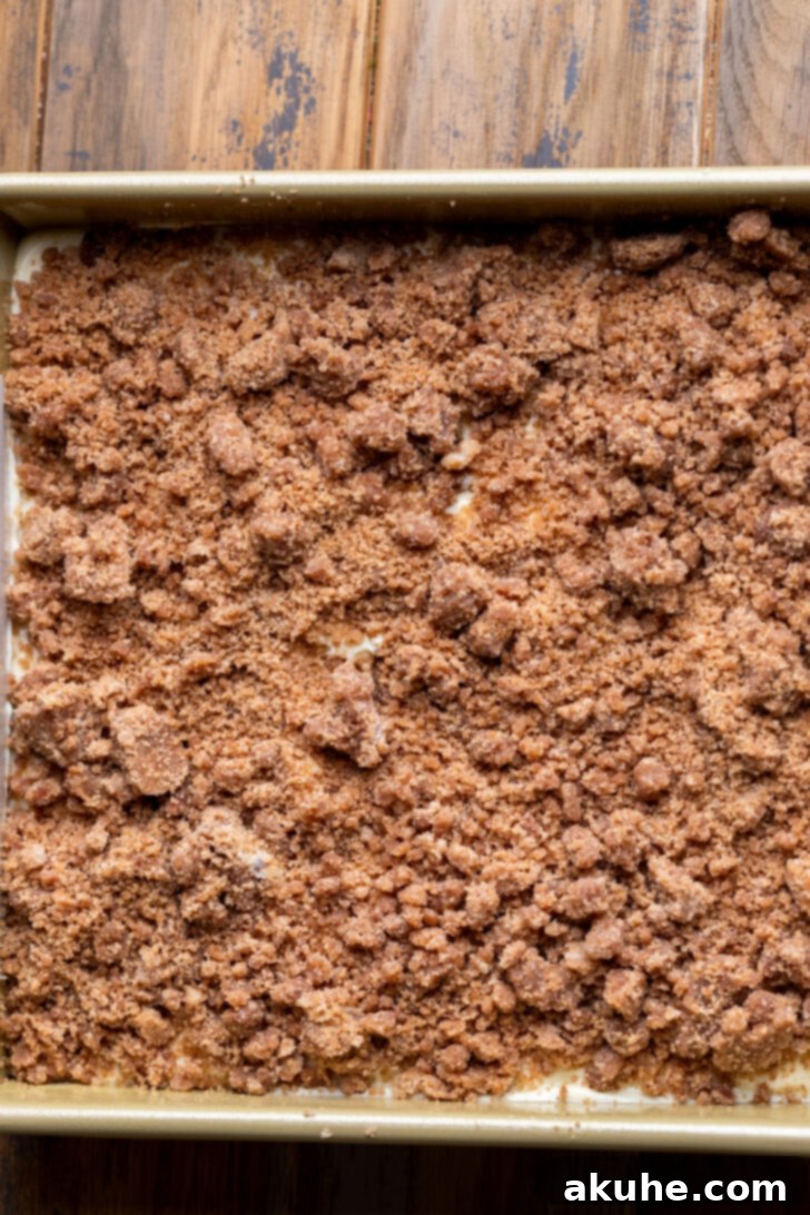 Autumn Pumpkin Streusel Cake 9 Cinnamon crumble generously sprinkled over the cream cheese layer in the pan.